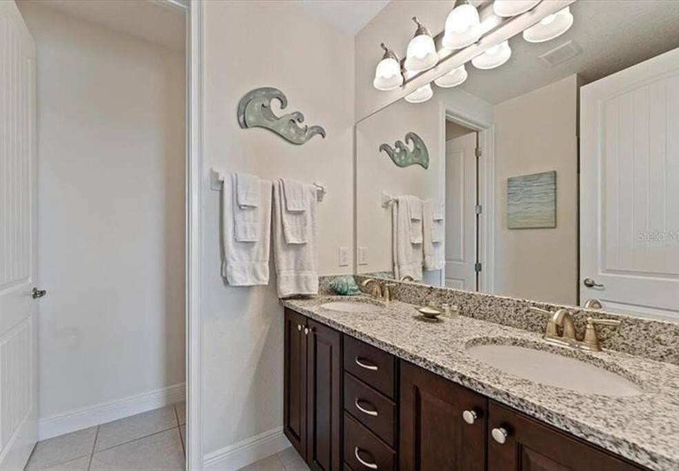 a bathroom with two sinks and a large mirror at 371 P Luxury Villa- New Listing in Orlando