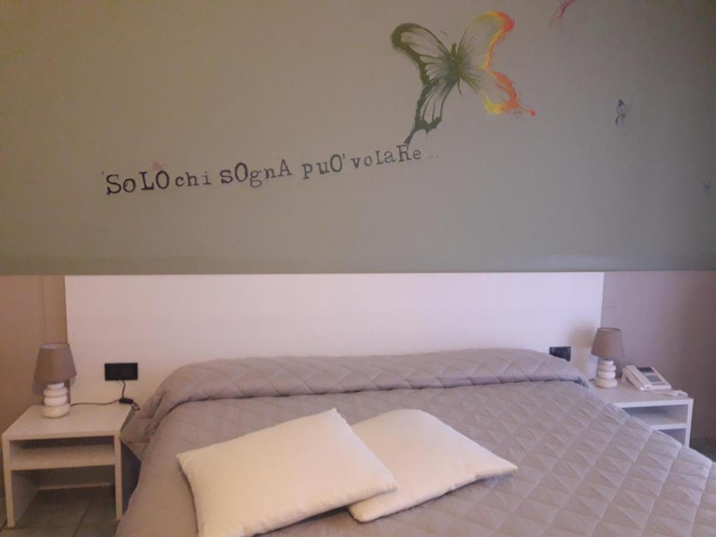 Postel nebo postele na pokoji v ubytování Hotel Stazione sul lago di Iseo