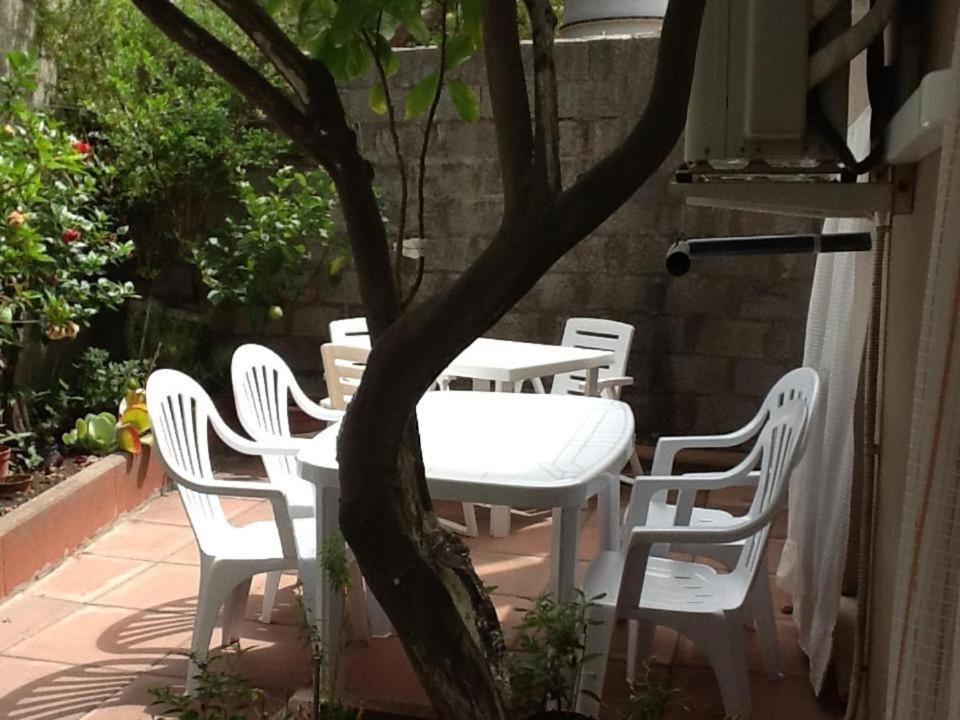 a white table and chairs on a patio at Teulada vacanze in Teulada