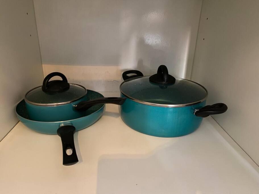 two pots sitting on top of a stove at Studio apartment in the heart of Dubai Marina. in Dubai