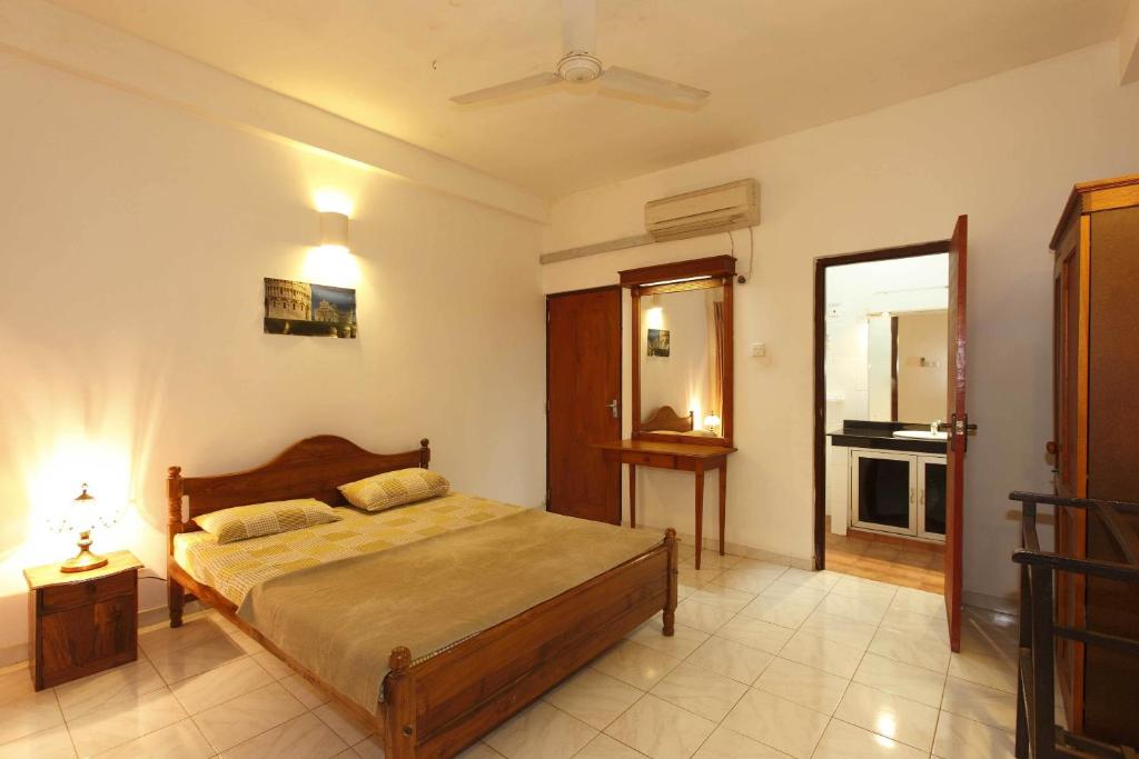 a bedroom with a large bed in a room at N S Apartment in Mount Lavinia