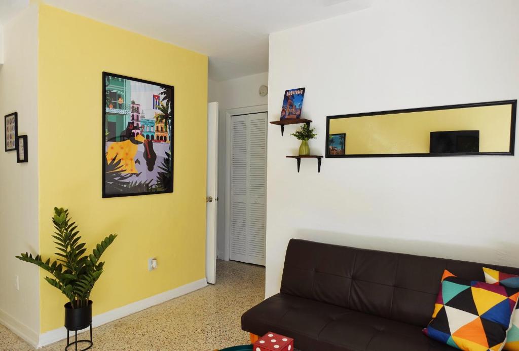 a living room with a couch and a yellow wall at Miami 1 Bedroom Apt With Parking in Miami