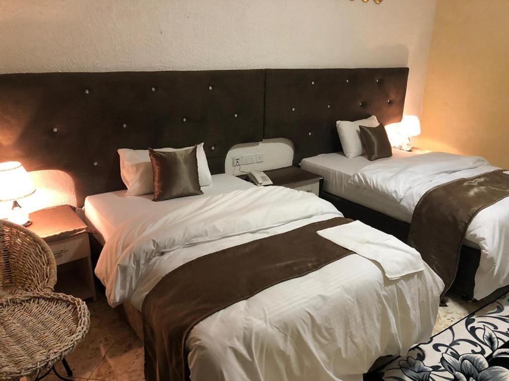 Postel nebo postele na pokoji v ubytování Nur Complex Hotel & Apartment