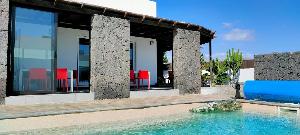 a villa with a swimming pool and a house at Villa Fedelian 2 Playa Blanca in Playa Blanca