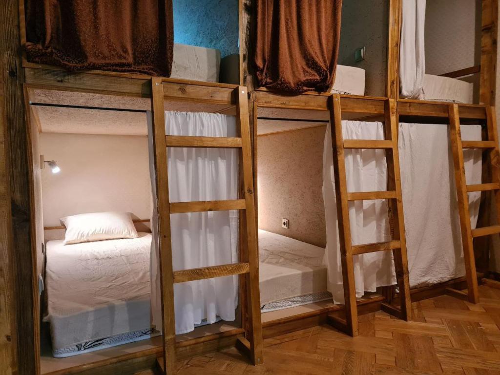 a group of four bunk beds in a room at Benevo Hostel in Tbilisi City