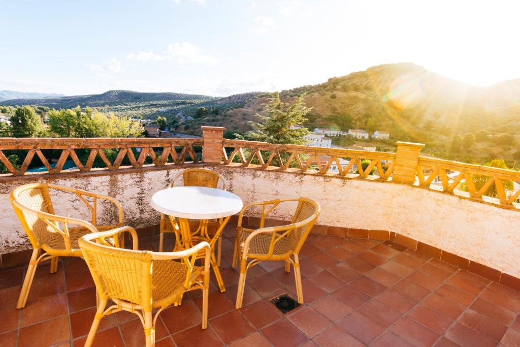 a patio with a table and chairs on a balcony at La Martina in Frailes