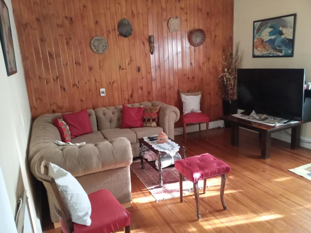 a living room with a couch and a tv at Wilson House in Buenos Aires