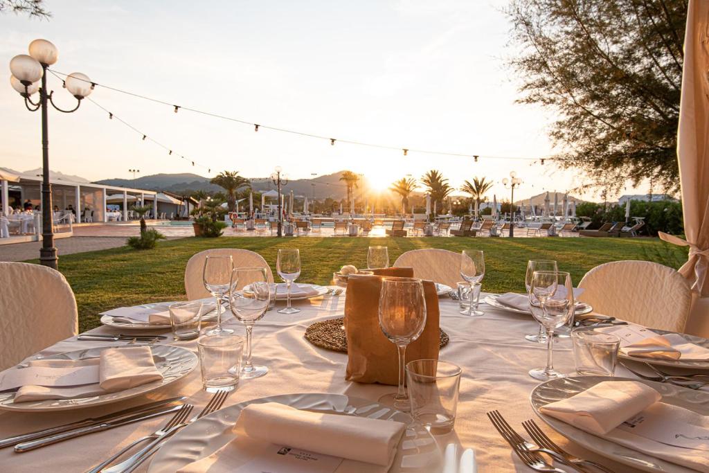 a table with glasses and plates and napkins on it at Hotel Airone isola d'Elba in Portoferraio