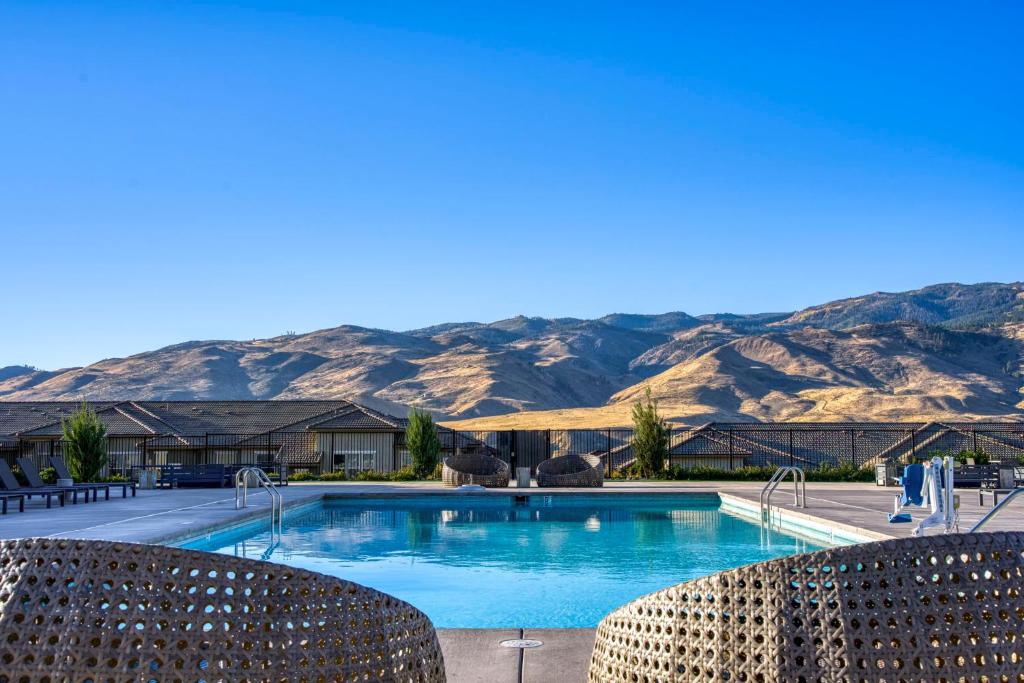 a swimming pool with mountains in the background at Luxury Retreat - King Beds, Hot Tub, & Pool - Family & Remote Work Friendly in Reno