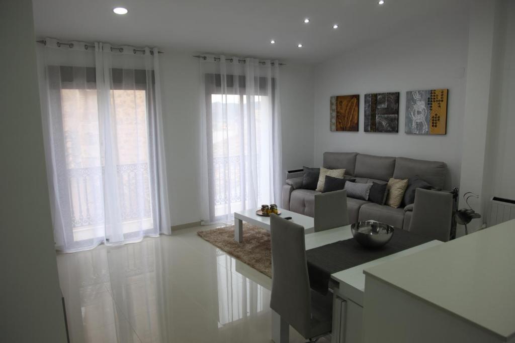 Apartamentos Alogia, Pastora, Yerbater في سيجوربي: غرفة معيشة مع أريكة وطاولة