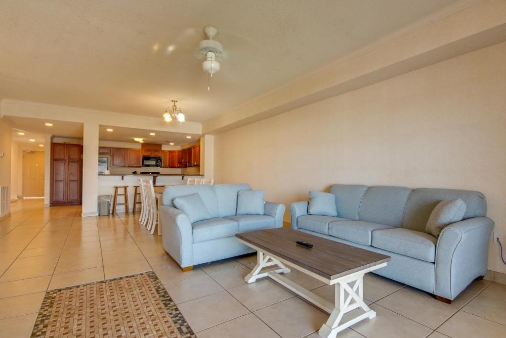 a living room with two blue chairs and a table at Americana Condos 10th street in Ocean City