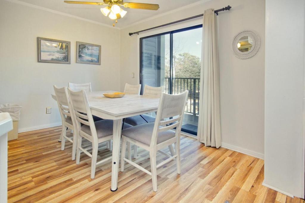 a kitchen and dining room with a table and chairs at Myrtle Beach Resort A349 in Myrtle Beach
