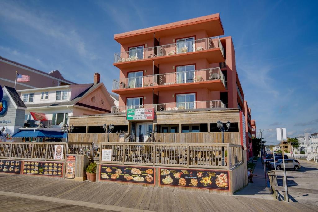 a building with balconies on the side of a boardwalk at Americana Motor Inn on Boardwalk in Ocean City