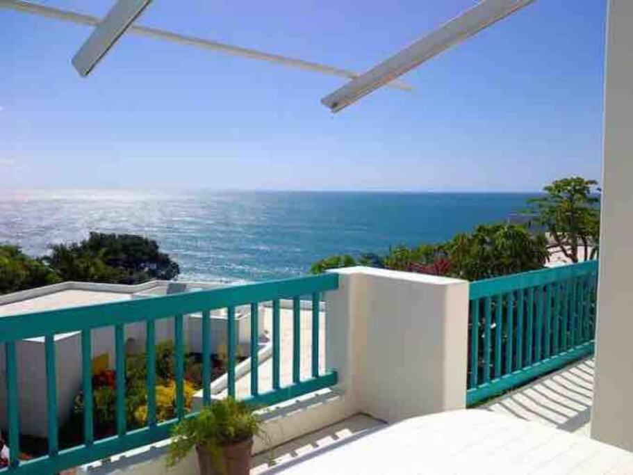 a balcony with a view of the ocean at 10 AKROTIRI, SANTORINI ESTATE - Families only in Ballito