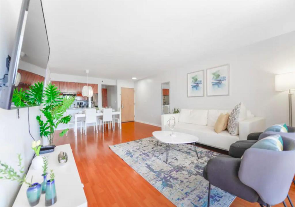 a living room with a white couch and a table at Exquisite Ocean View 3 BR Apartment in Miami