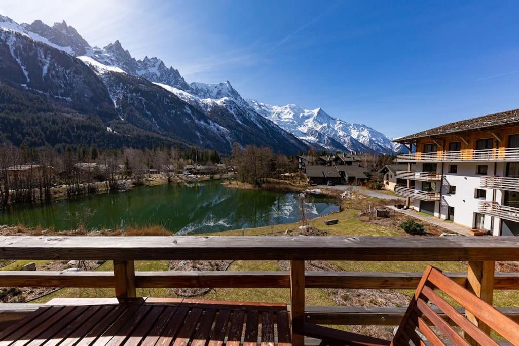 a view from the balcony of a resort with a lake at Modern 2BR 5* pool gym spa garage Mont-Blanc view in Chamonix-Mont-Blanc