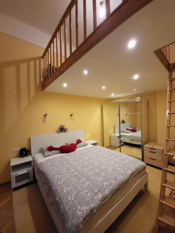 a bedroom with a large bed and a staircase at M Apartments - Downtown 2 in Budapest