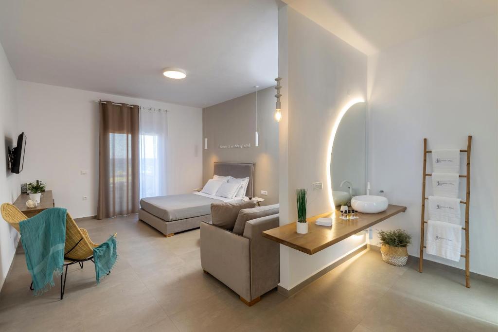 a living room with a couch and a bed at Vivianna's View in Azolimnos Syros