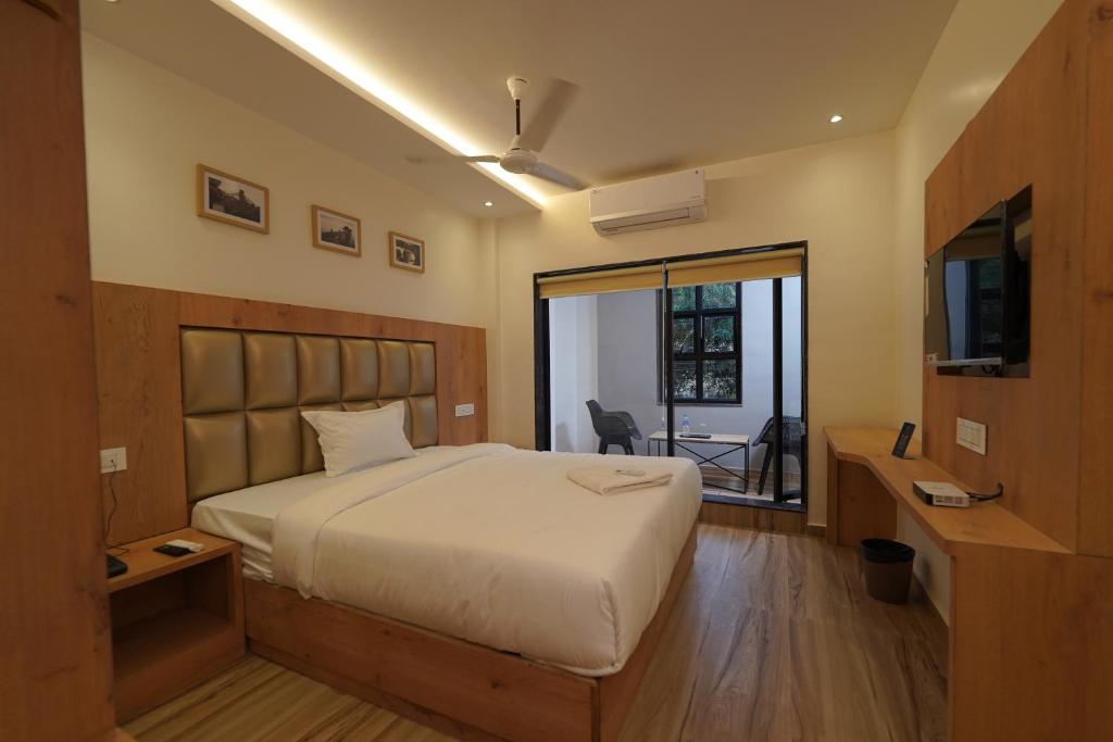 a bedroom with a large bed and a sliding glass door at Southern Residency in Cochin