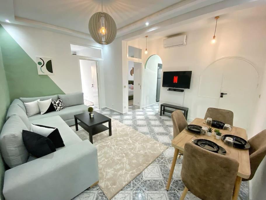 a living room with a couch and a table at Cosy appartement Next to Majorelle Garden in Marrakech