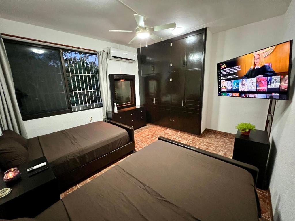 a living room with a couch and a flat screen tv at Family in Minatitlán