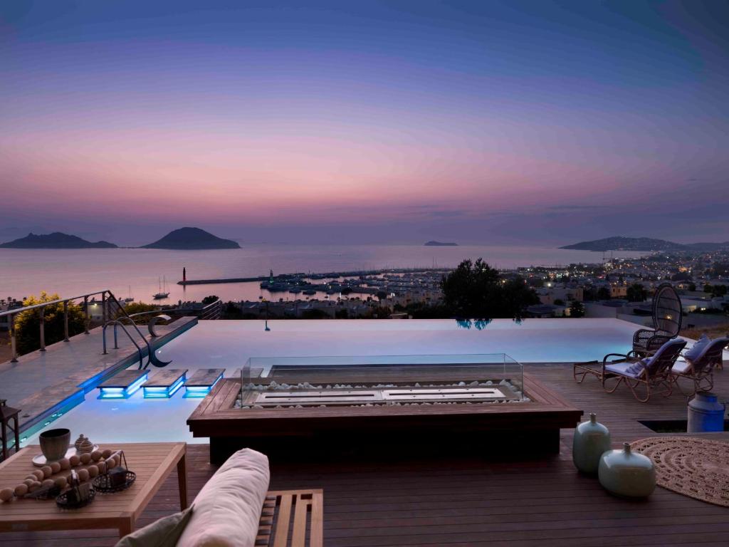 a large swimming pool with a view of the ocean at Marinhill - High Luxury Villa in Bodrum City