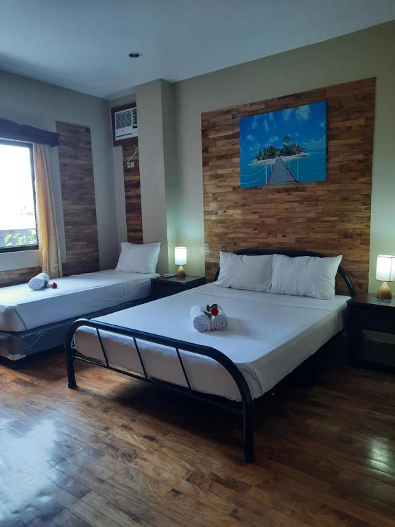 Postel nebo postele na pokoji v ubytování Mabini Hotel