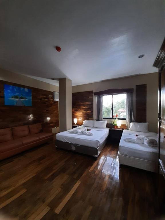 Postel nebo postele na pokoji v ubytování Mabini Hotel