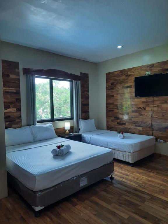 Postel nebo postele na pokoji v ubytování Mabini Hotel