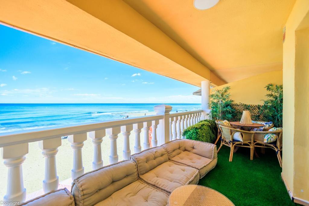 a living room with a couch and a view of the ocean at Primera linea de playa , increíbles vistas, amplio in La Mata