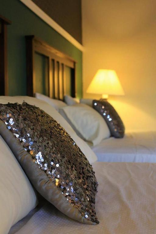 Postel nebo postele na pokoji v ubytování Hotel Plaza Yat Balam Anexo