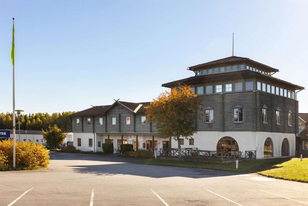 a large building with a clock tower on top of it at Sure Hotel by Best Western Dalhall in Åmål