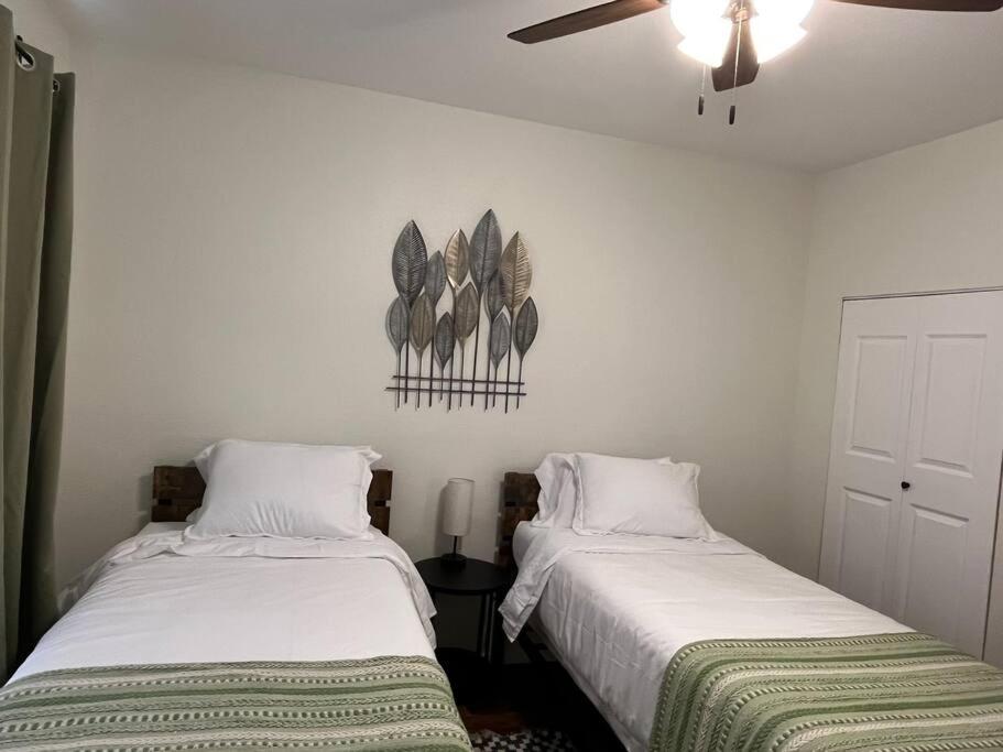 two beds sitting next to each other in a room at Home Away From Home-Cozy 2 BDRM Condo/Med Cntr/NRG in Houston