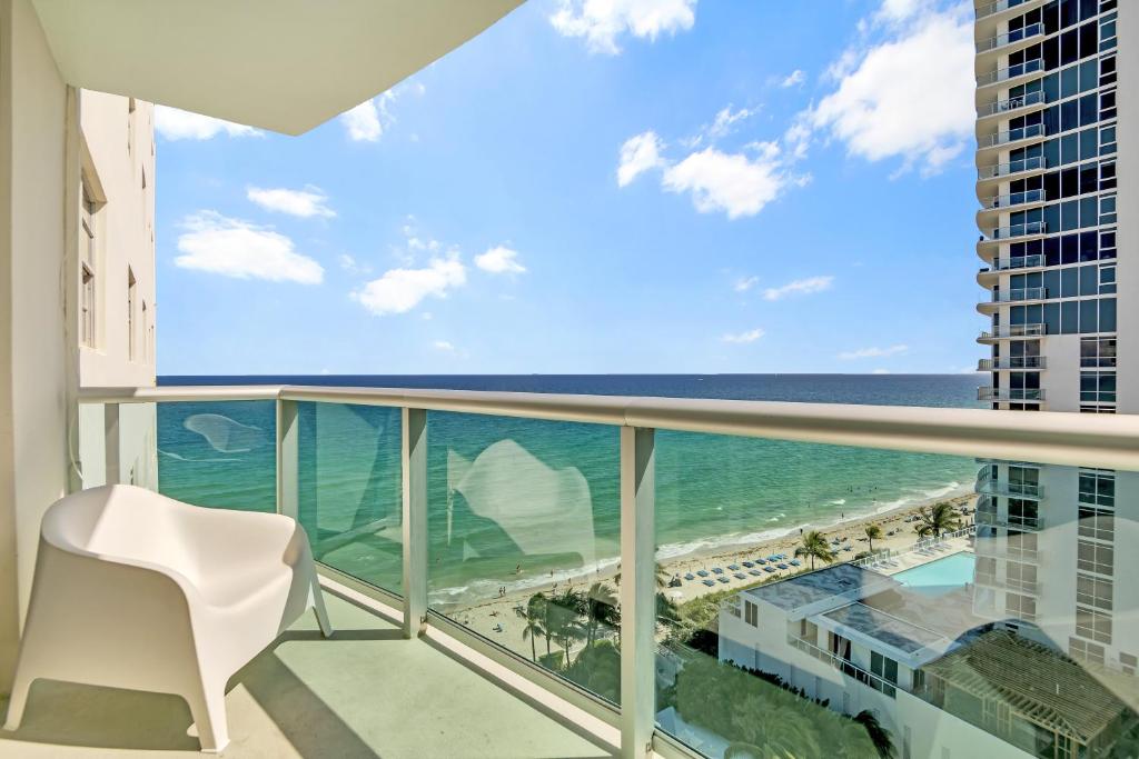 a balcony with a view of the ocean and a white chair at THE TIDES 2bedrooms apt 14th floor WE ARE ON THE BEACH! in Hollywood