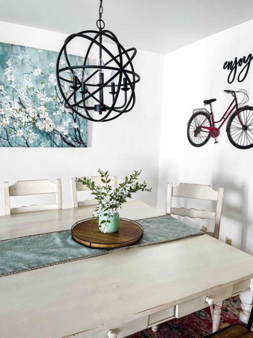 a dining room with a table and a chandelier at Swiss Corner Cottage - Private-Heated Indoor Pool in Santa Clara