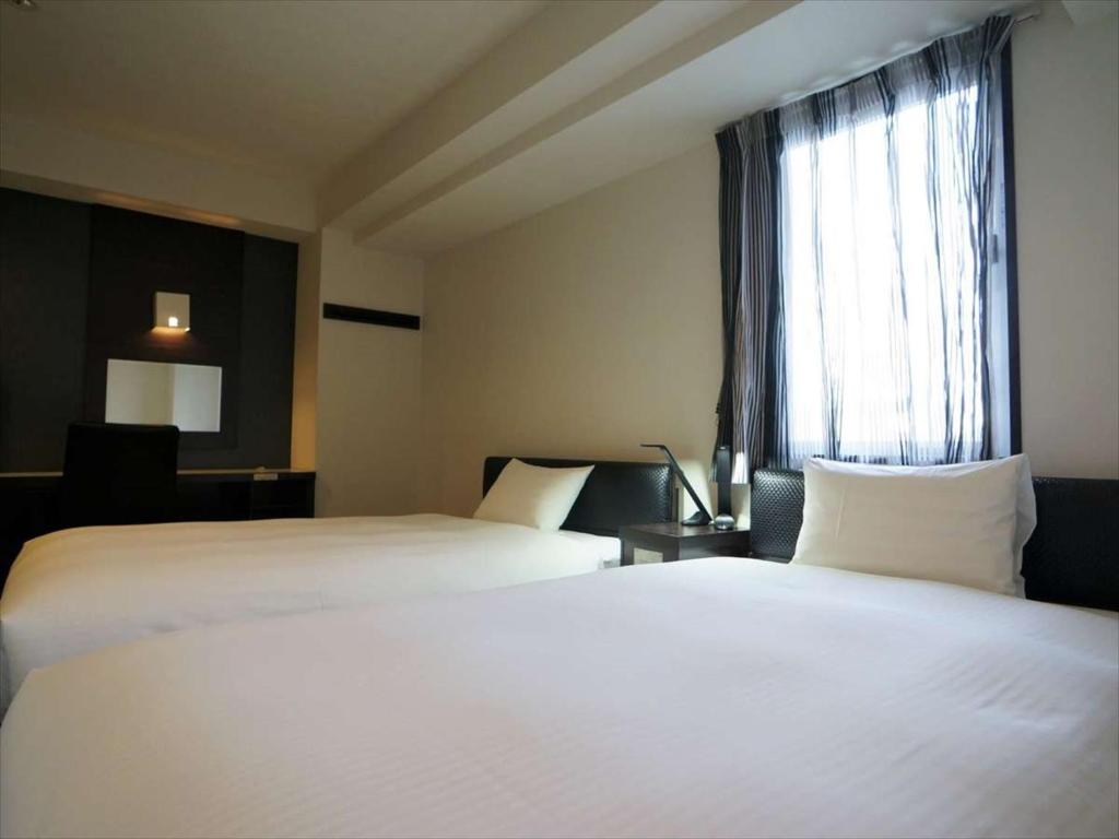 Postel nebo postele na pokoji v ubytování Green Rich Hotel Osaka Airport
