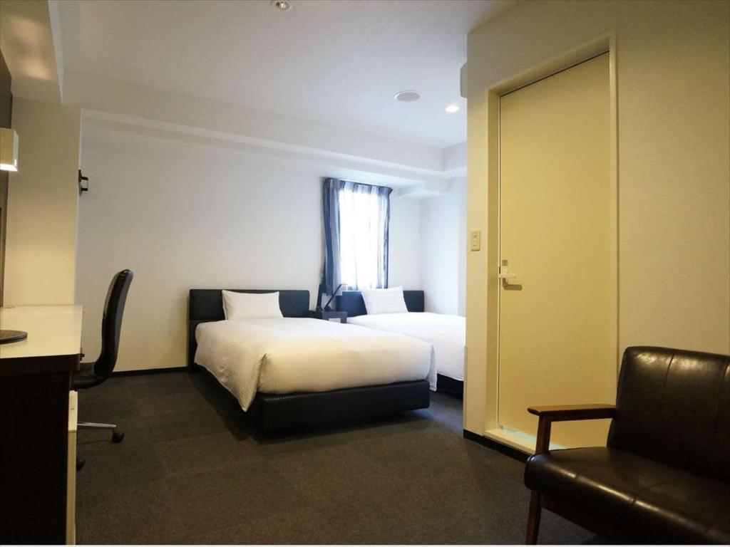 Postel nebo postele na pokoji v ubytování Green Rich Hotel Osaka Airport