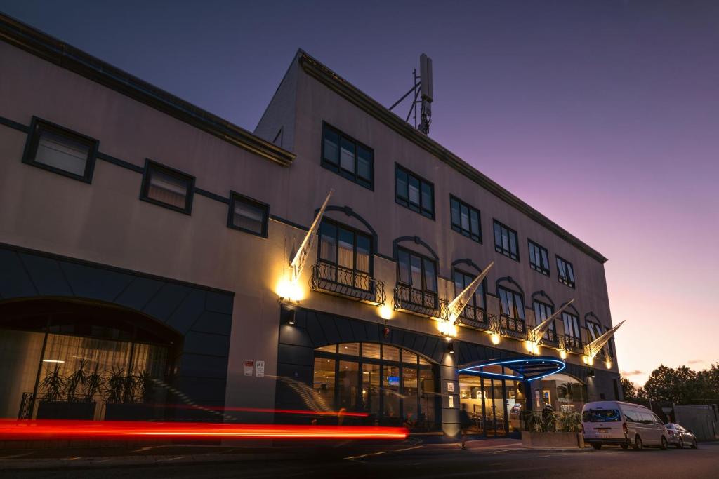 a building with lights on the side of it at Great Southern Hotel Perth in Perth