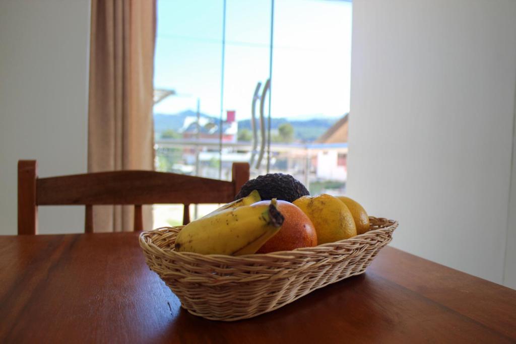 una cesta de fruta sobre una mesa de madera en Hospedaje San Antonio, en Oxapampa