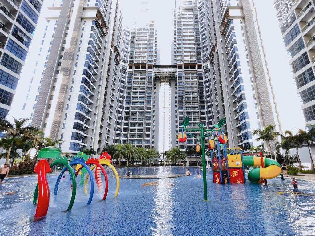 a water park in front of tall buildings at Atlantis Residences Melaka by HeyStay Management in Melaka