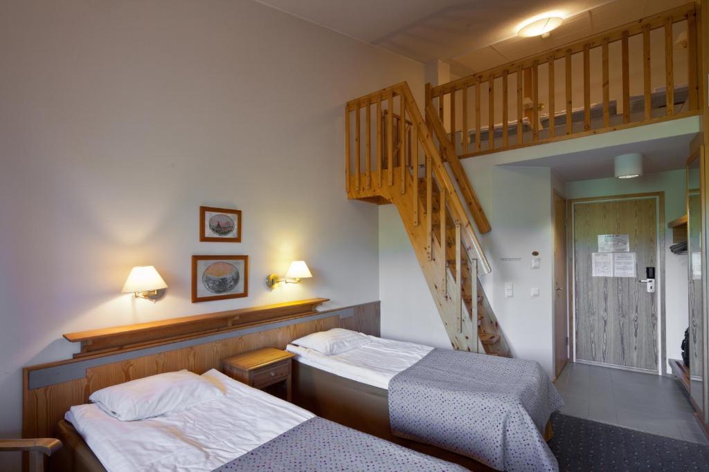 Postel nebo postele na pokoji v ubytování Lapland Hotels Luostotunturi & Amethyst Spa
