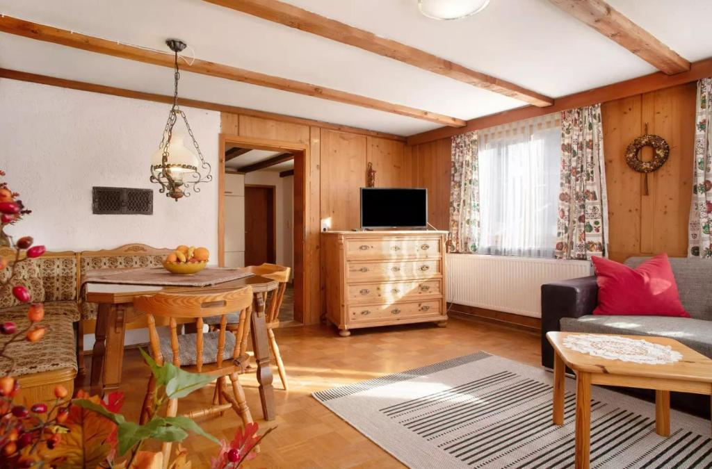 a living room with a couch and a table at Allgäuer Stube in Oberstaufen