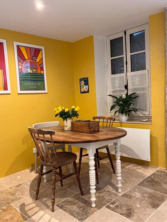 a dining room with a wooden table and chairs at Maison Marie in Lagarde