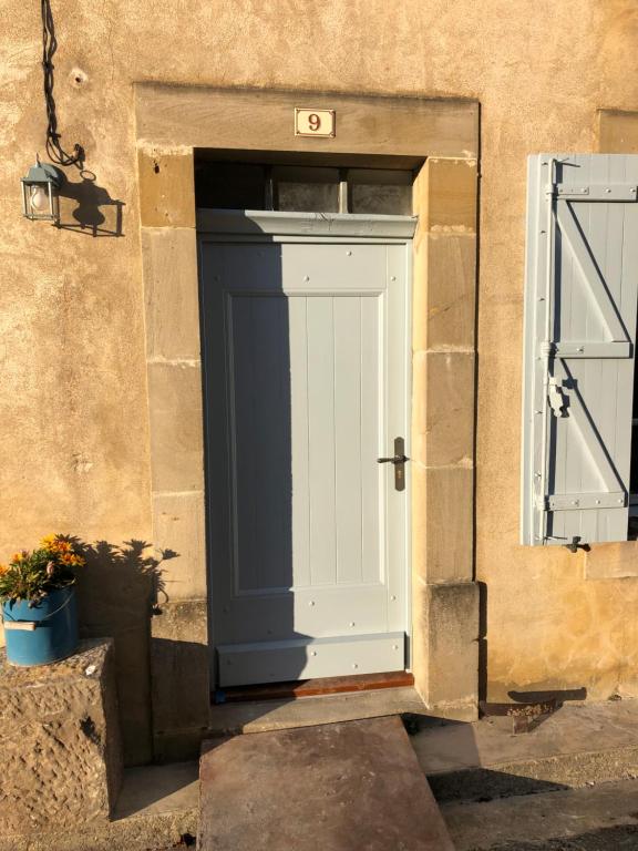 a door with the number sixteen on it next to a building at Maison Marie in Lagarde