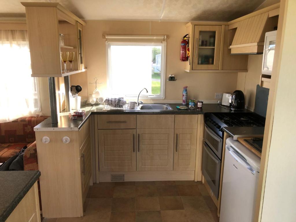 a small kitchen with a sink and a stove at Steeple Bay F79 in Steeple