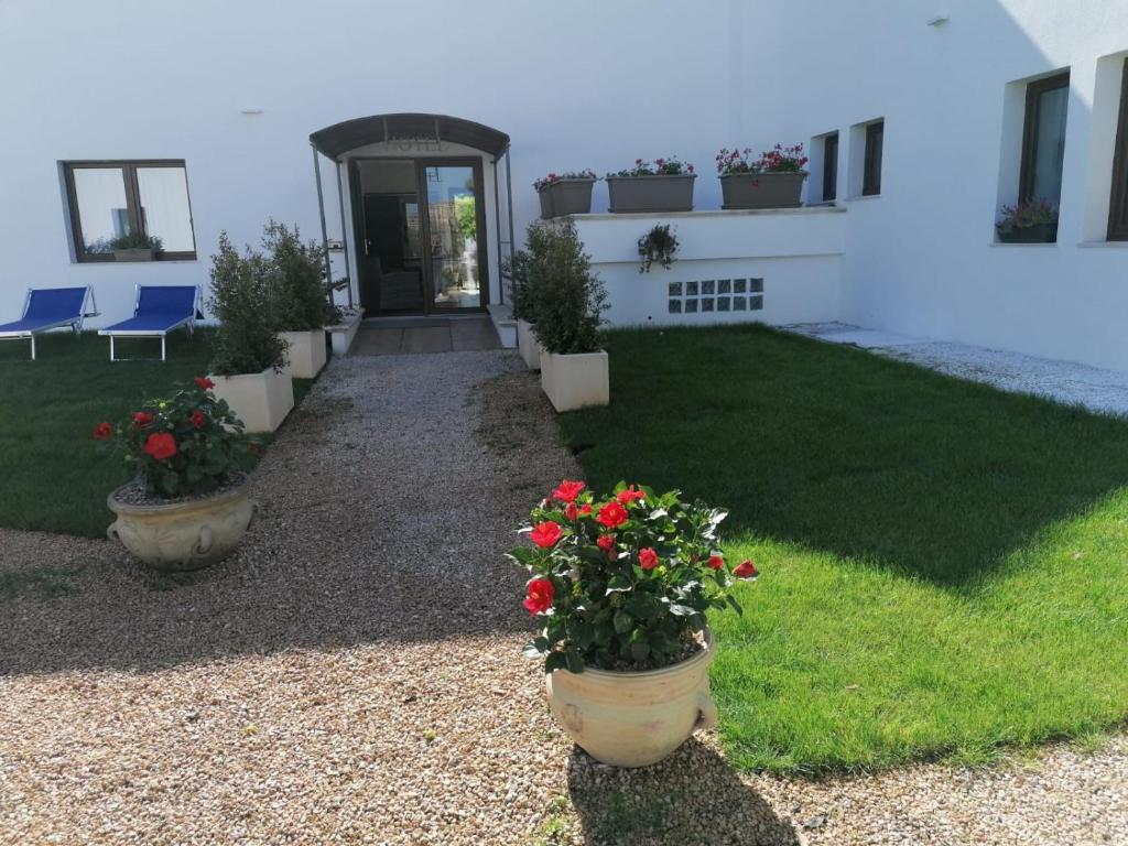 a house with flower pots in front of it at Hotel Villa Sveva in Cagliari