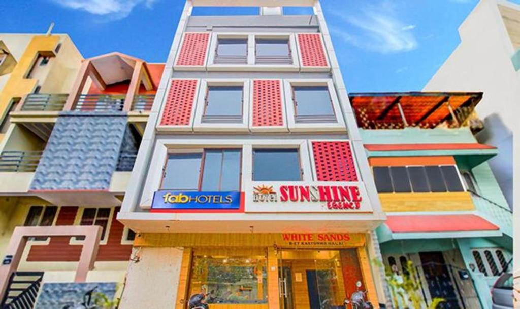 a tall building with a sun king sign on it at FabExpress Sunshine Regency in Bhopal