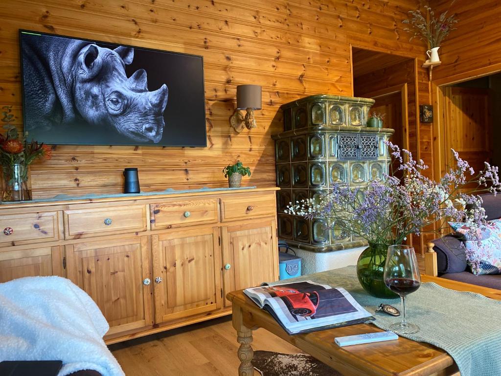 a living room with a tv on a wooden wall at My Happy Garden 1500sq m in Ochsenfurt