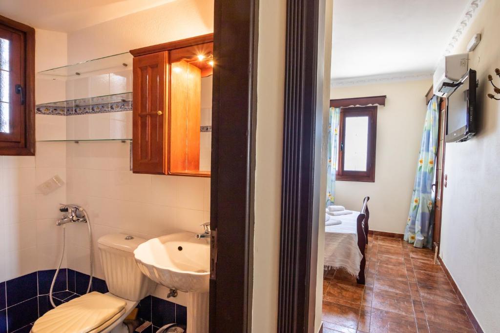 a small bathroom with a sink and a toilet at Oceanviewvilla in Karpathos