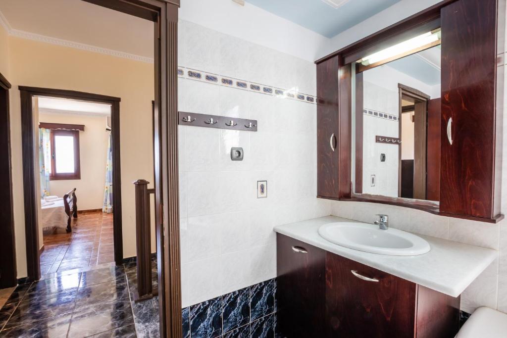 a bathroom with a sink and a mirror at Oceanviewvilla in Karpathos